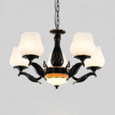 Ornate black & gold chandelier with frosted glass shades dining room