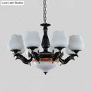 Ornate black & gold chandelier with frosted glass shades dining room