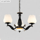 Ornate black & gold chandelier with frosted glass shades dining room