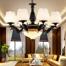 Ornate black & gold chandelier with frosted glass shades dining room