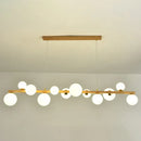 Modern gold and wood pendant with frosted globe shade dining room