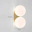 Minimalist brass and glass ball art wall lamp for bedroom