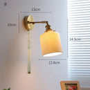 Ribbed white glass and brass ceramic wall sconce for bedroom lighting