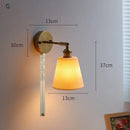 Ribbed white glass and brass ceramic wall sconce for bedroom lighting