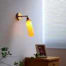 Ribbed white glass and brass ceramic wall sconce for bedroom lighting