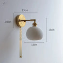 Ribbed white glass and brass ceramic wall sconce for bedroom lighting