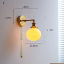 Ribbed white glass and brass ceramic wall sconce for bedroom lighting