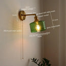 Green ribbed glass wall sconce with pull chain switch for bedroom