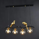 Modern bird branch island pendant light – dining room amber glass