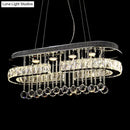 DecorBites™ Modern LED Crystal Pendant Light with Stainless Steel Frame and Tassel Accents