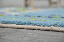 Blue geometric moroccan handmade azilal rug bedroom decor with tassels