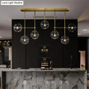 Modern brass and black clear glass sphere ceiling light dining room
