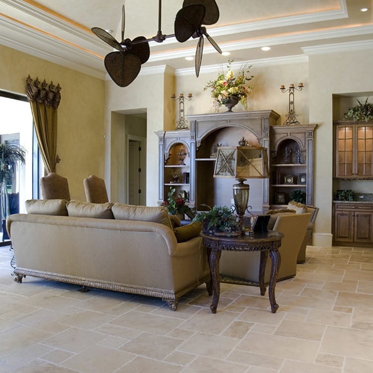 Denizli Beige Antique Pattern Travertine Tile - Full Truckload brushed chiseled installed on traditional living room floor with unique ceiling fan