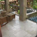 Denizli Beige Antique Pattern Travertine Tile - Full Truckload Brushed and chiseled installed outdoor balcony with rattan furniture