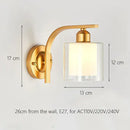 Elegant gold iron wall lamp with frosted glass shade for bedroom