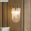 Elegant gold wall lamp with twisted crystal shade for bedroom