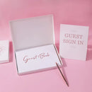 Elegant white guest book with bronzing detail – wedding reception