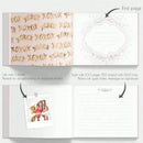 Elegant white guest book with bronzing detail – wedding reception