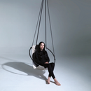 faux leather hanging round chair pearl product shot woman sitting on it