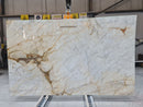 Marble slab with beige and white pattern in a warehouse setting