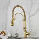Golden kitchen faucet with white ceramic handle and swivel spout
