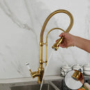 Golden kitchen faucet with white ceramic handle and swivel spout