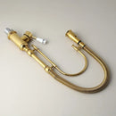 Golden kitchen faucet with white ceramic handle and swivel spout