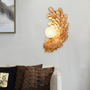 Golden peacock wall light with crystal shade – living room yellow & green