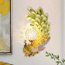 Golden peacock wall light with crystal shade – living room yellow & green