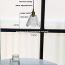 Green glass pendant light with copper canopy for dining room