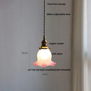 Green glass pendant light with copper canopy for dining room