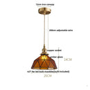 Green glass pendant light with copper canopy for dining room