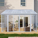 White framed sunroom attached to a house with patio furniture inside