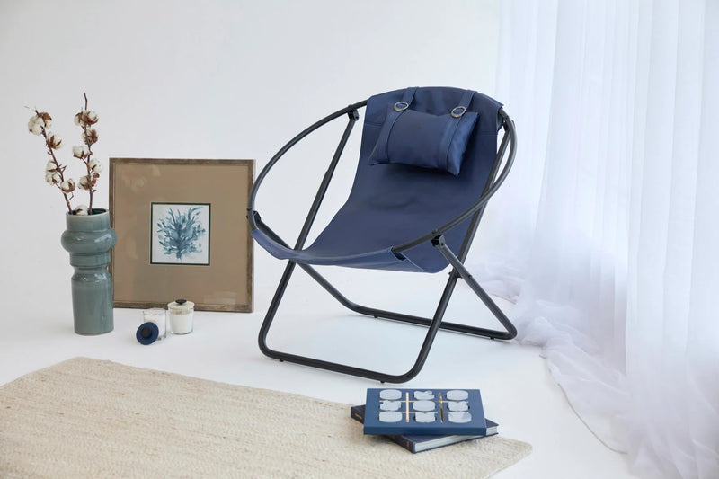 indigo foldable metal frame faux -chair black metal frame product shot decorative items around wide view