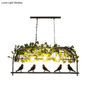 Industrial black birdcage kitchen pendant light with plant decoration