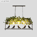 Industrial black birdcage kitchen pendant light with plant decoration