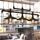 Industrial black pipe chandelier with red valve caps dining room light