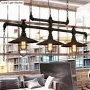 Industrial black pipe chandelier with red valve caps dining room light
