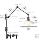 Industrial black swing arm wall light fixture with faceted glass shade