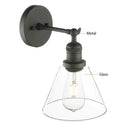 Industrial black wrought iron wall lamp with clear glass shade bedroom