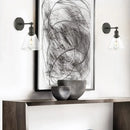 Industrial black wrought iron wall lamp with clear glass shade bedroom