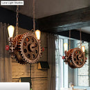 Industrial brass gear pendant light dining room with red accents