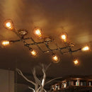 Industrial brass intersecting piping ceiling light dining room cage