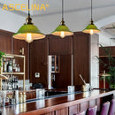 Industrial green glass pendant light dining room with brass accents