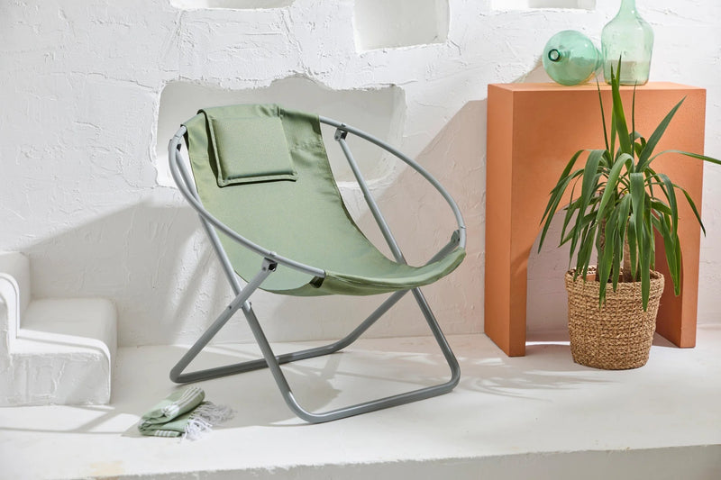 lare aurora green foldable metal frame canvas chair gray metal frame product shot green vases plant inside wicker planter green peshtemal on floor