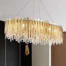 Luxurious gold elliptical island light fixture with clear crystal dining room