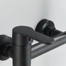 Matte black wall mounted waterfall bathtub faucet with handheld spray