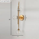 Mid century brass finish 3 light clear glass orb sconce living room