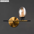 Mid century gold and black wall lamp with amber glass shade bedroom