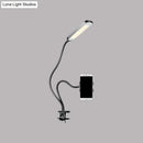 Minimalist black flexible arm desk lamp with phone holder bedroom